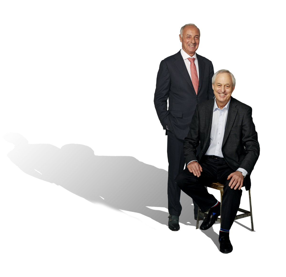 Two elderly businessmen in black suits
